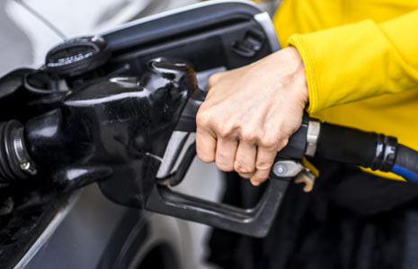 Closeup of Hand Pumping Gas Into Car