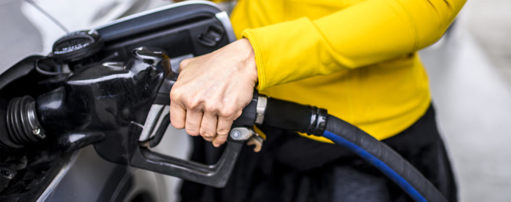 Closeup of Hand Pumping Gas Into Car